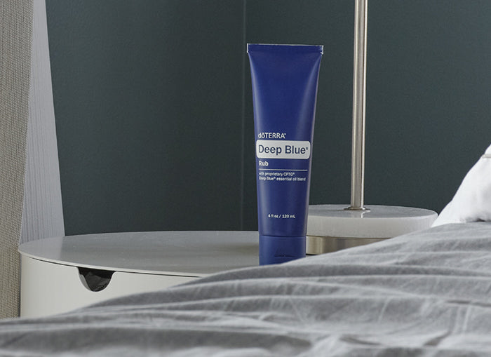 dōTERRA Deep Blue Rub tube on a bedside table
