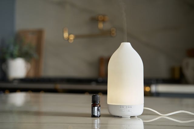 A white ultrasonic diffuser on a desk