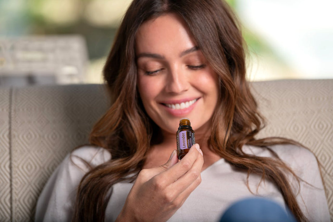 A woman using a roll-on essential oil blend